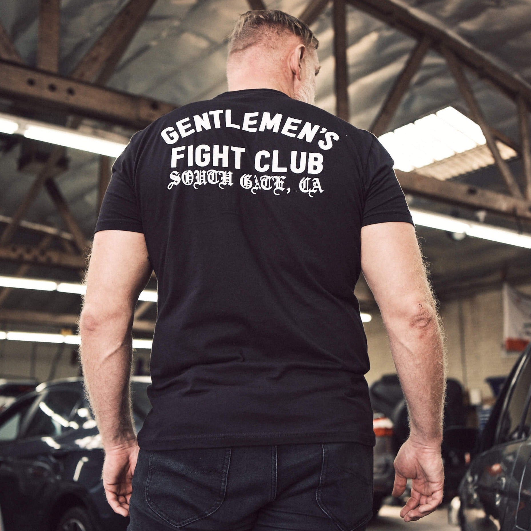 Josh Barnett is wearing a tee.  The back reads 'Gentlemen's Fight Club, South Gate, CA'