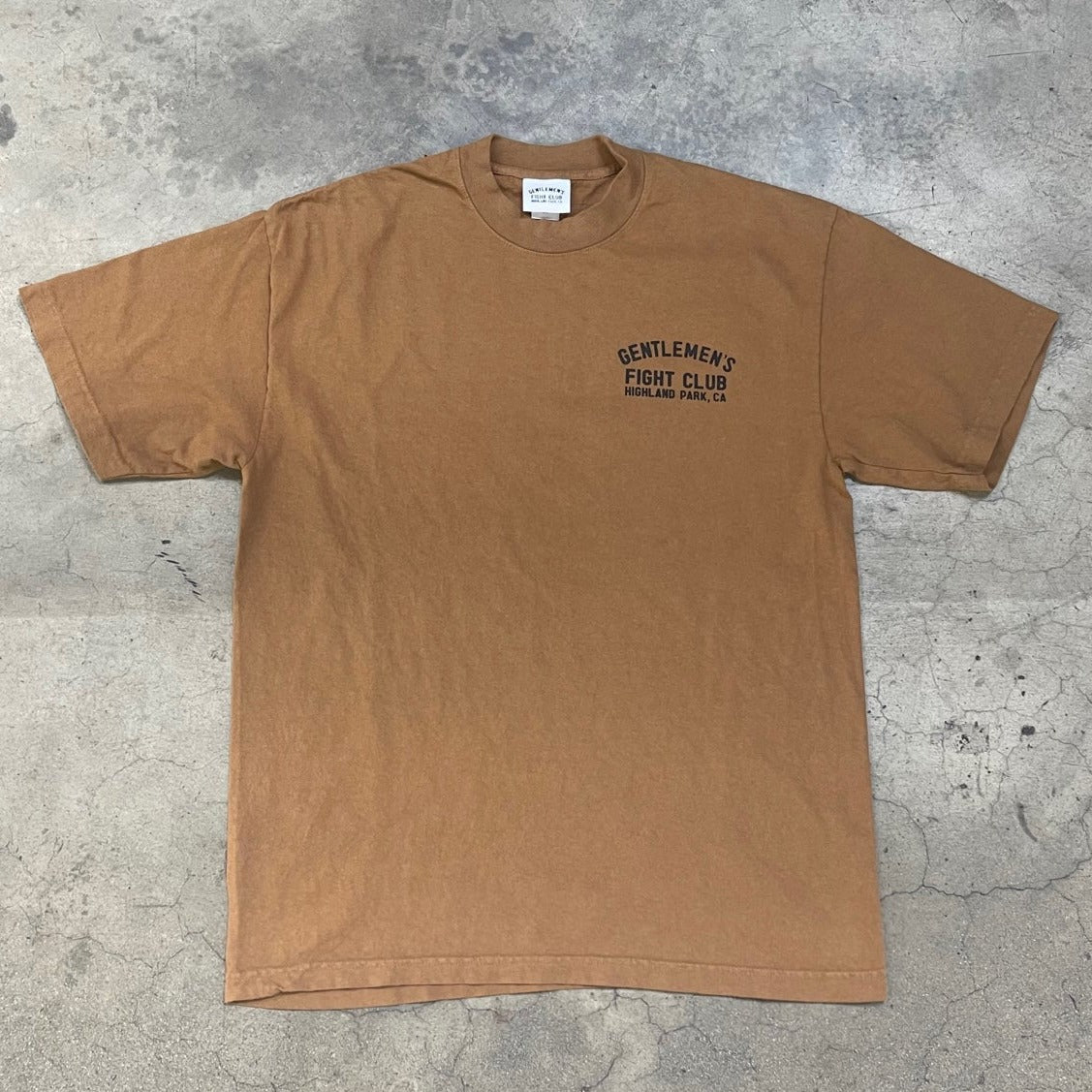Front of whiskey brown tee with black print that reads "Gentlemen's Fight Club Highland Park, CA"
